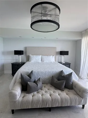 a bedroom with a bed tv and window