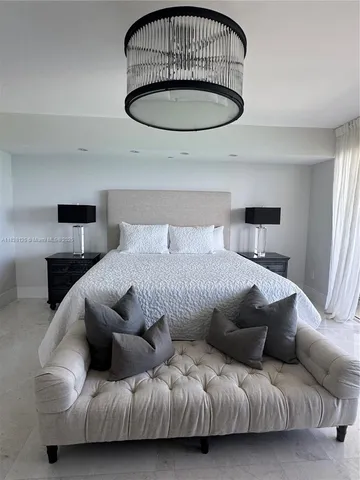 a bedroom with a bed tv and window