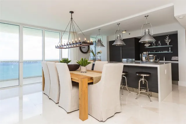 a kitchen with a table a stove and a chandelier