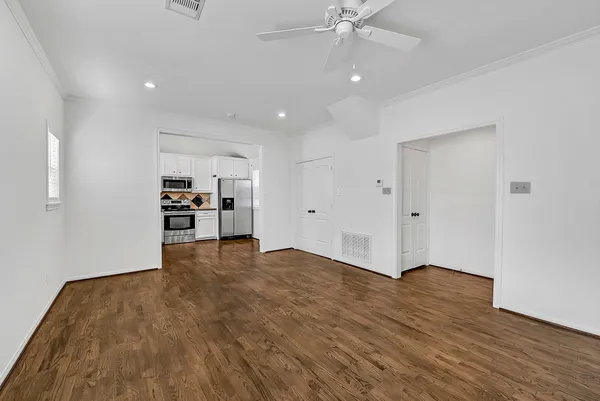 a view of empty room with wooden floor