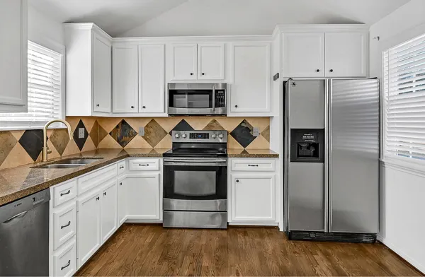 a view of a kitchen with electric appliances