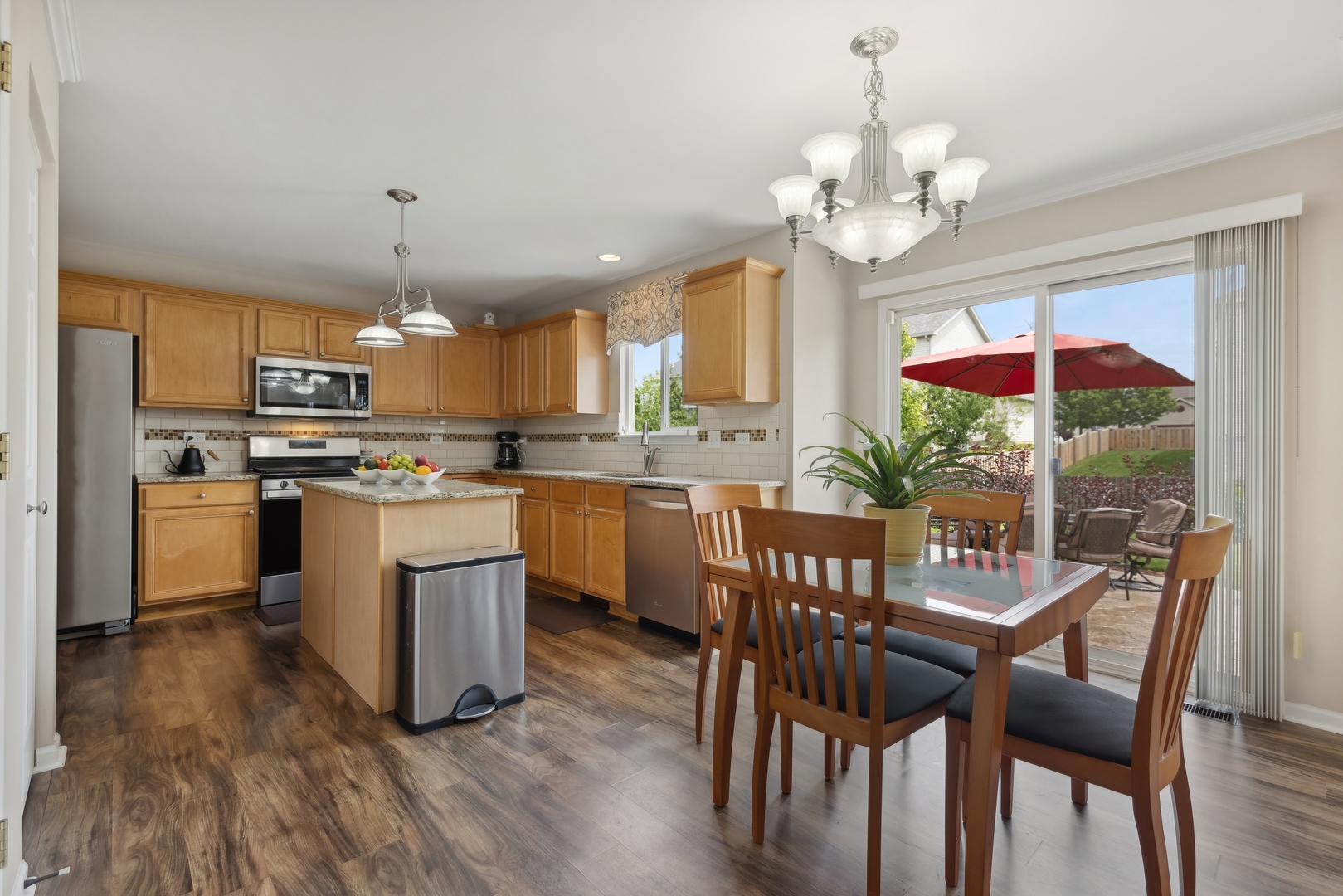 373 Foster Way Bolingbrook, IL 60440 - Photo 5 of 35 a kitchen with a dining table chairs stainless steel appliances and cabinets