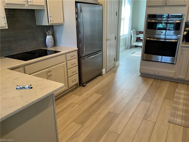 a kitchen with stainless steel appliances kitchen island wooden cabinets and granite counter tops
