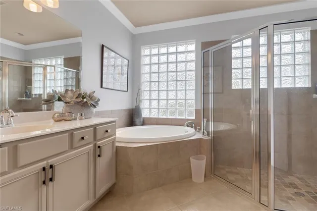a bathroom with a double vanity sink toilet and shower