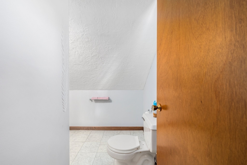 31 Tyson Road Worcester, MA 01606 - Photo 17 of 27 a bathroom with a granite countertop white toilet and a sink