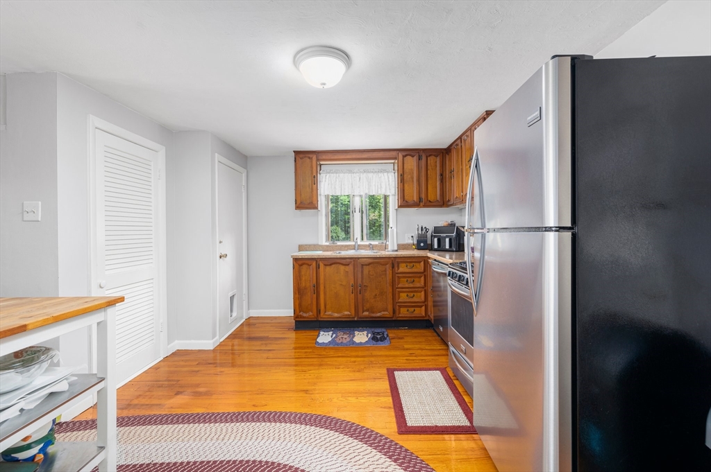 31 Tyson Road Worcester, MA 01606 - Photo 2 of 27 a bedroom with a bed and a refrigerator