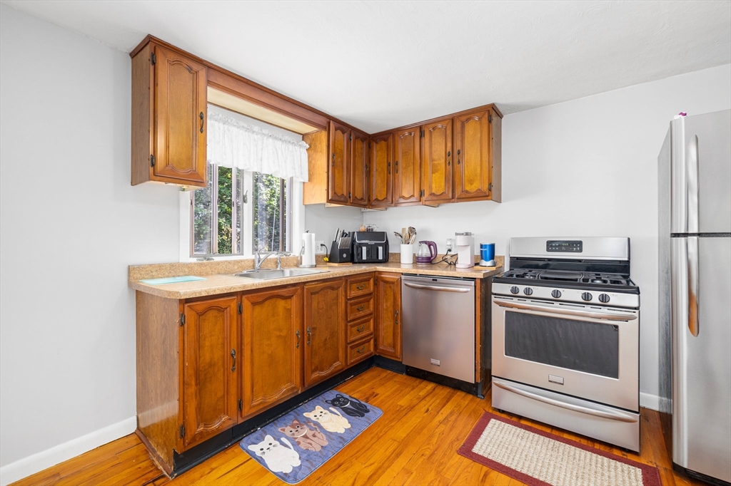 31 Tyson Road Worcester, MA 01606 - Photo 4 of 27 a kitchen with stainless steel appliances granite countertop a stove a sink and a refrigerator