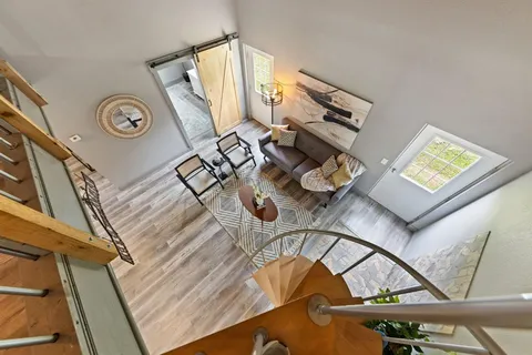 a view of empty room with wooden floor