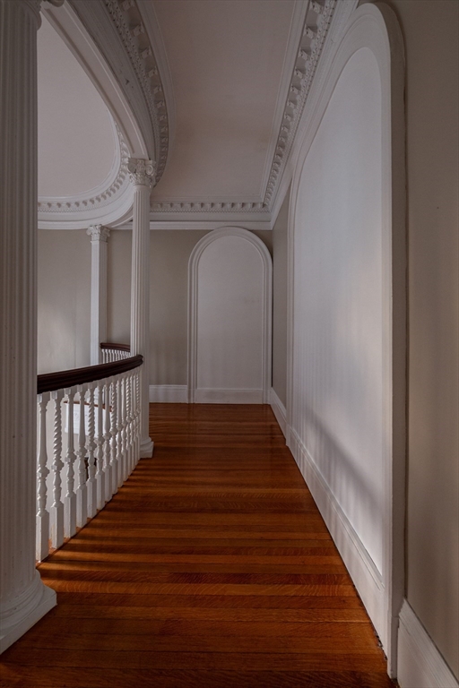11 Wayne Street Boston, MA 02121 - Photo 13 of 27 a view of a hallway with wooden floor and staircase