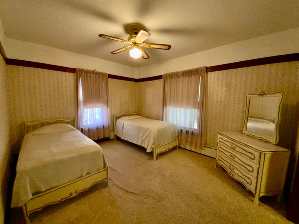 a spacious bedroom with a bed and furniture
