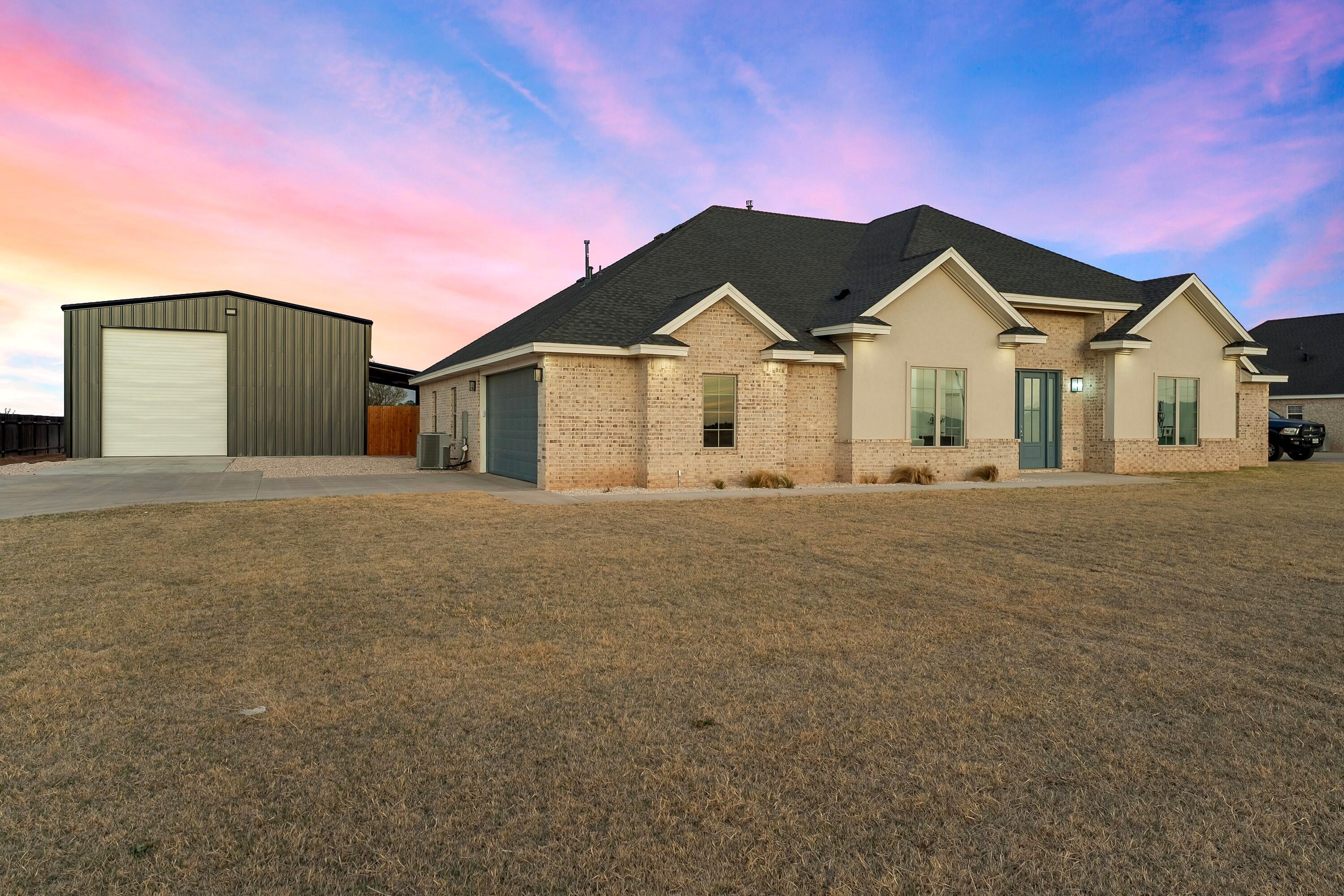 19215 County Road 2240 Lubbock, TX 79423 - Photo 1 of 36 a front view of a house with a yard