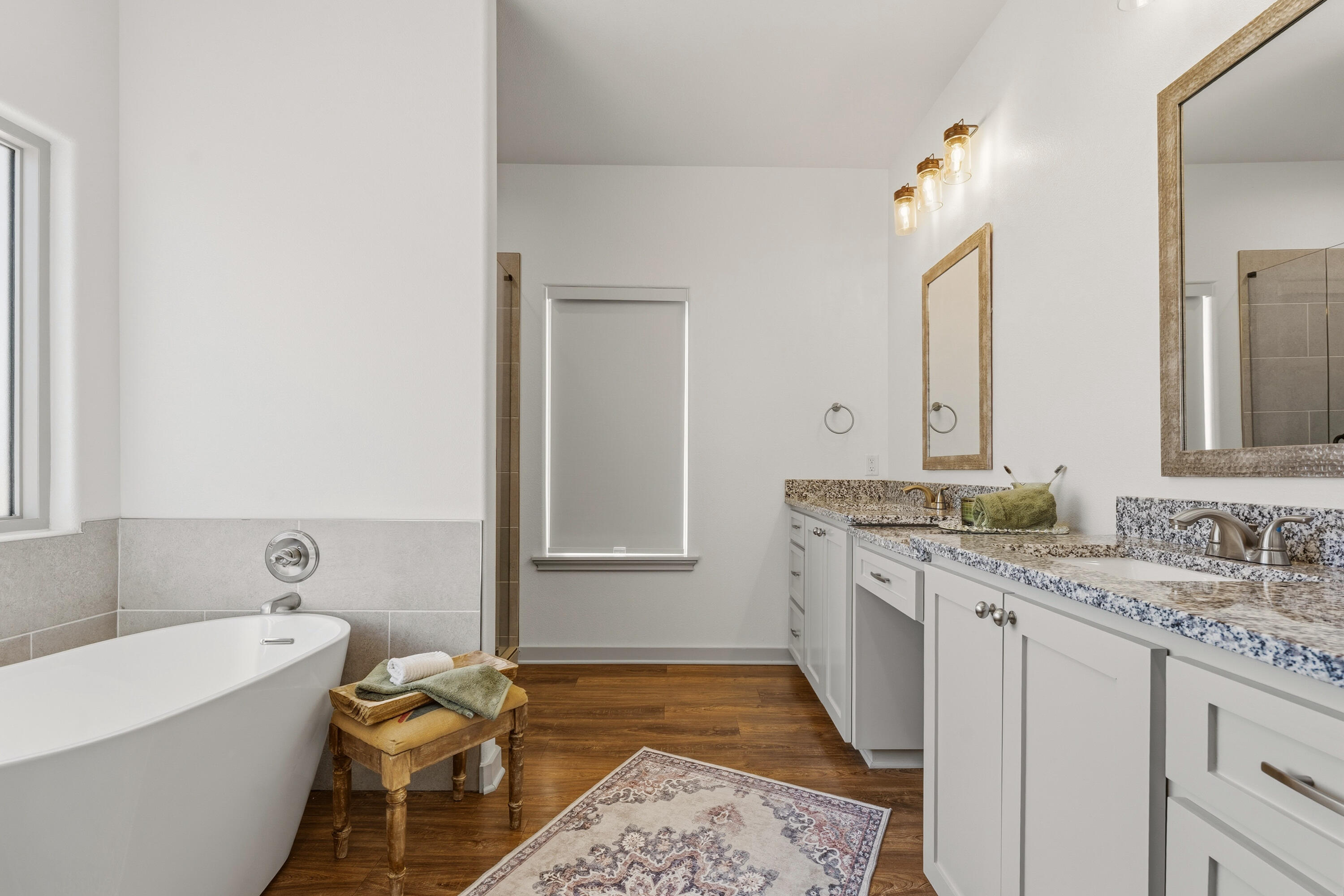 19215 County Road 2240 Lubbock, TX 79423 - Photo 18 of 36 a spacious bathroom with a granite countertop sink and a mirror