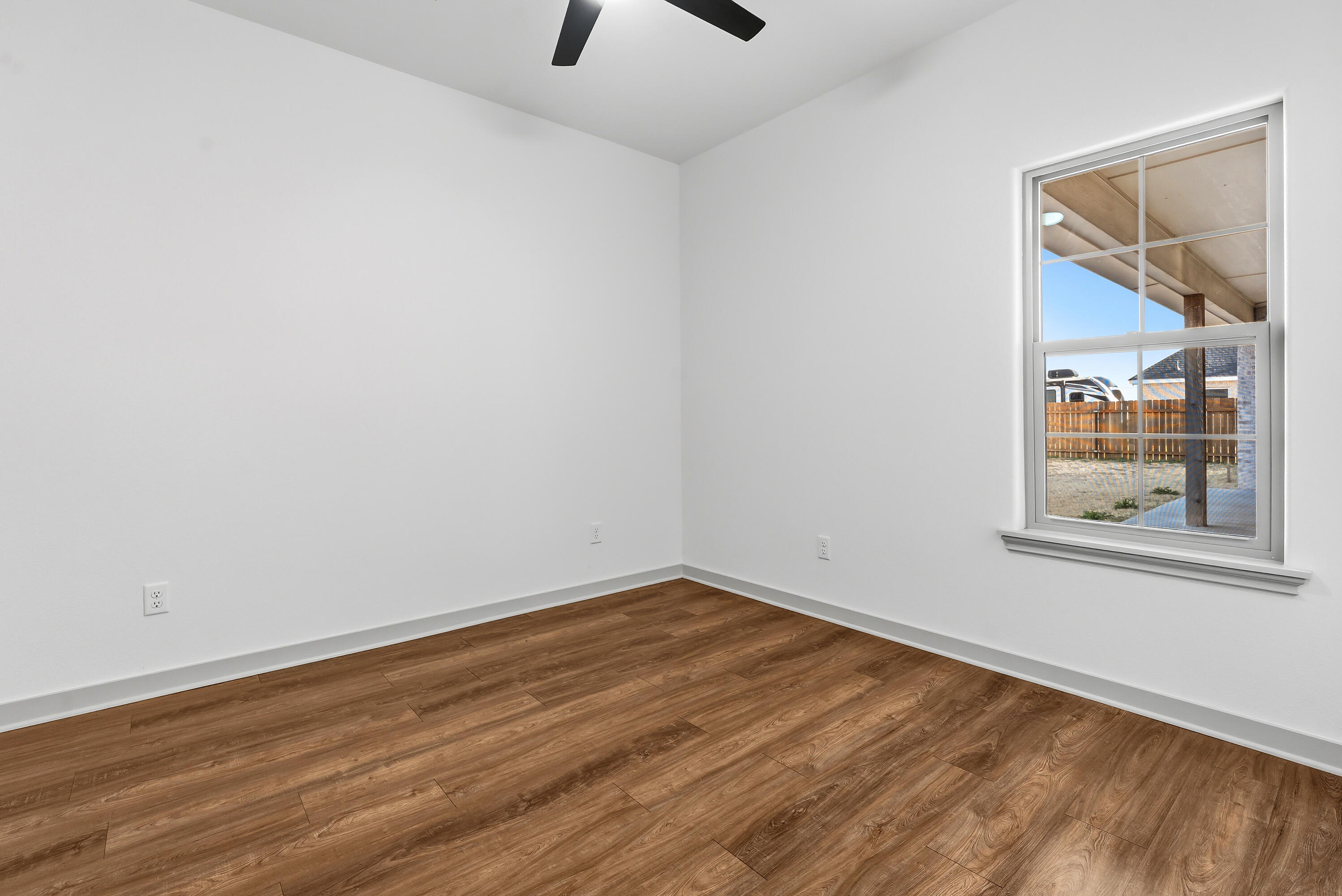 19215 County Road 2240 Lubbock, TX 79423 - Photo 21 of 36 a view of a room with wooden floor and a window