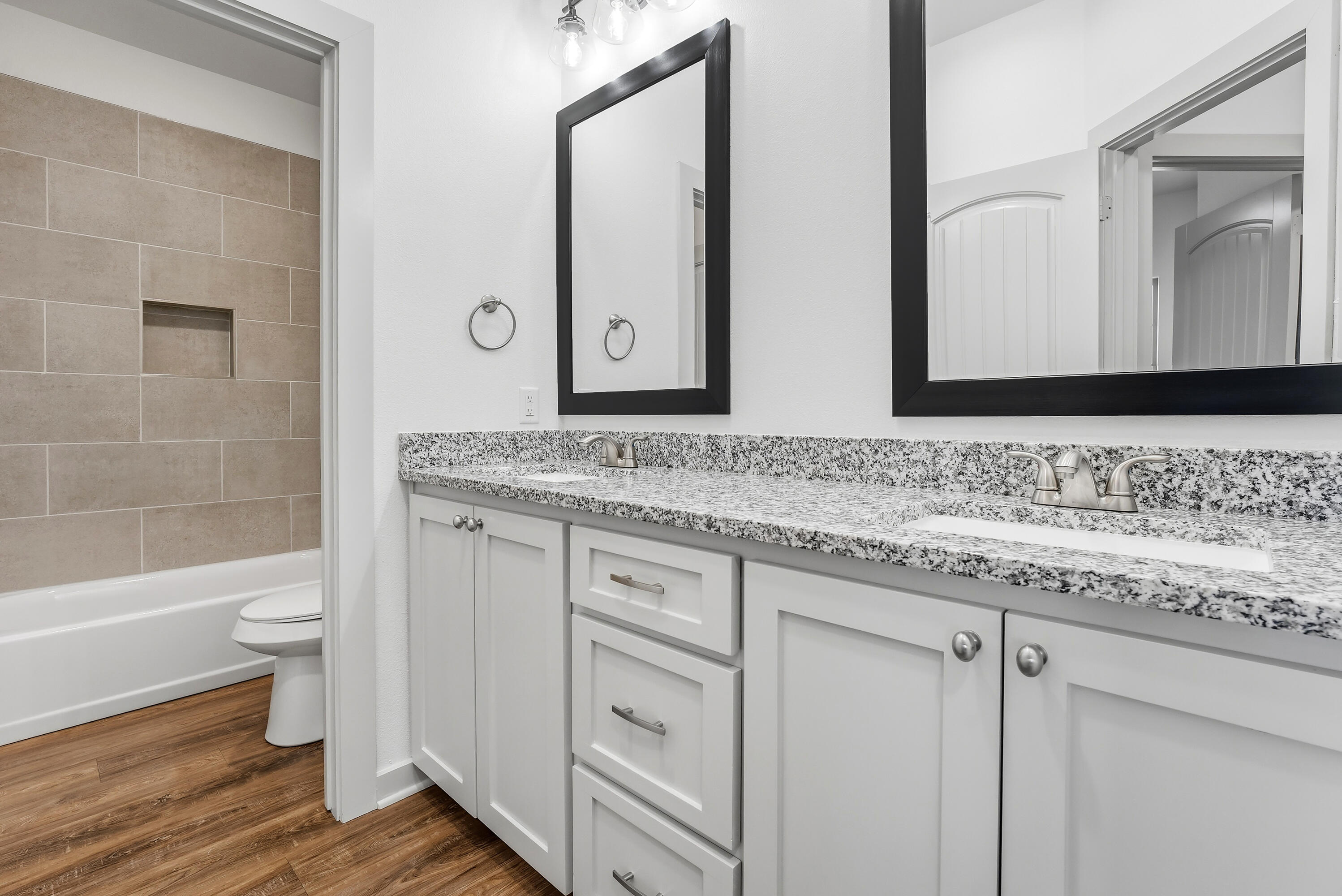 19215 County Road 2240 Lubbock, TX 79423 - Photo 25 of 36 a bathroom with a granite countertop toilet sink and mirror