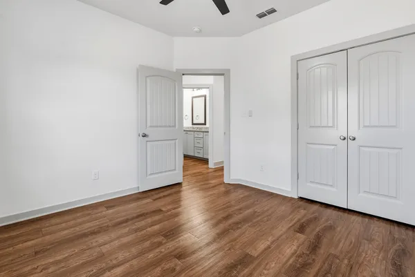 a bathroom with a granite countertop toilet sink and mirror