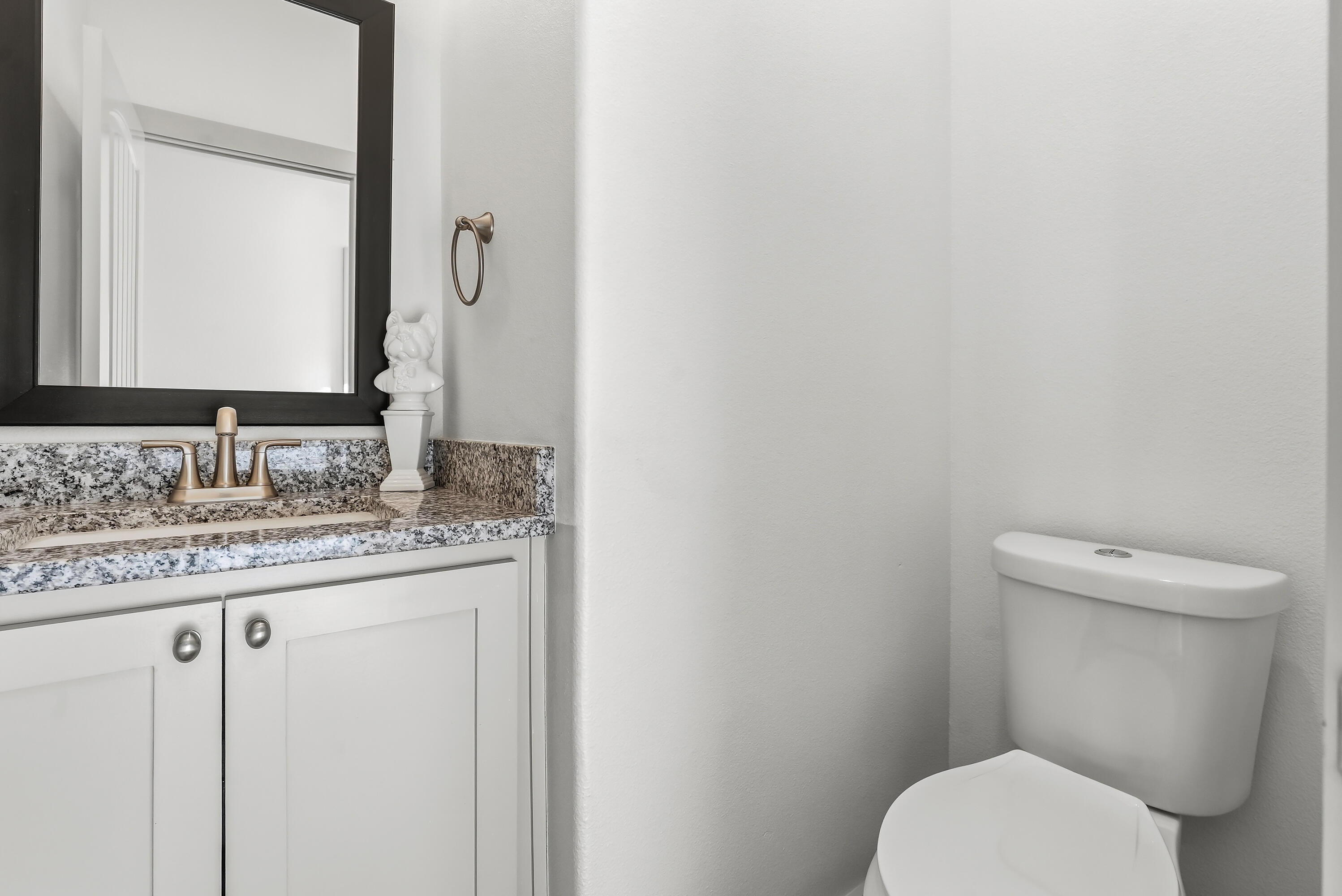 19215 County Road 2240 Lubbock, TX 79423 - Photo 28 of 36 a bathroom with a granite countertop toilet sink and mirror
