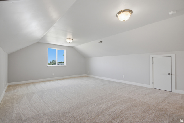 1252 Skyline Road Saratoga Springs, UT 84045 - Photo 28 of 51 Spacious attic room featuring sloped ceilings, light carpeting, and neutral wall tones