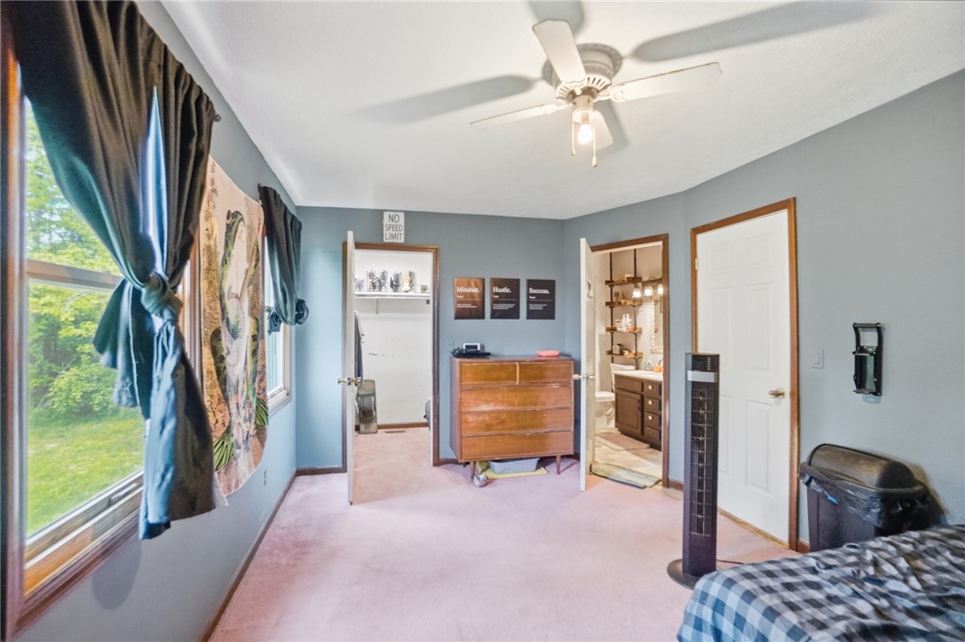 5209 North Addison New Carlisle Road St. Paris, OH 43072 - Photo 28 of 47 This spacious bedroom offers ample natural light and direct access to a private closet and bathroom.