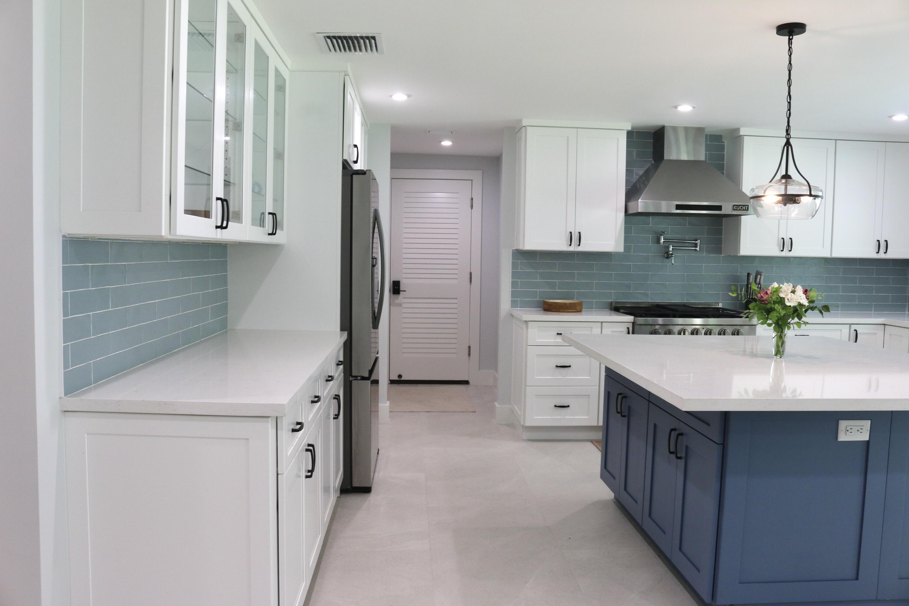 41 Sunset Road Key Largo, FL 33037 - Photo 16 of 59 a kitchen with a sink a stove a refrigerator and white cabinets