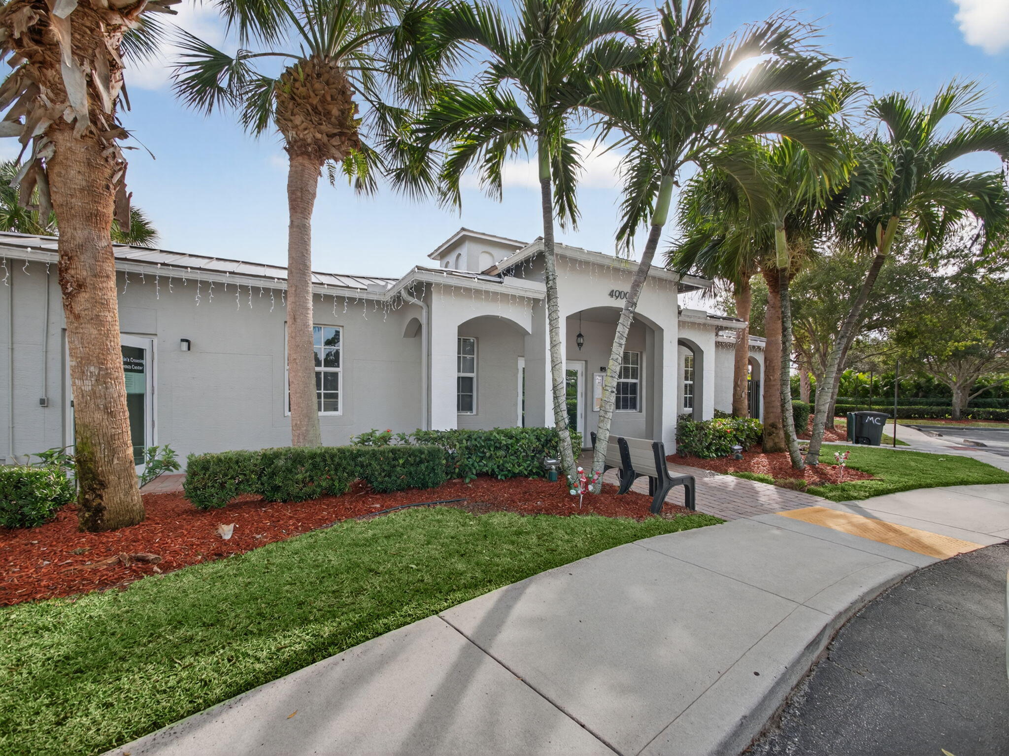 4358 Southeast Graham Drive Stuart, FL 34997 - Photo 29 of 34 a front view of a house with a garden and palm trees