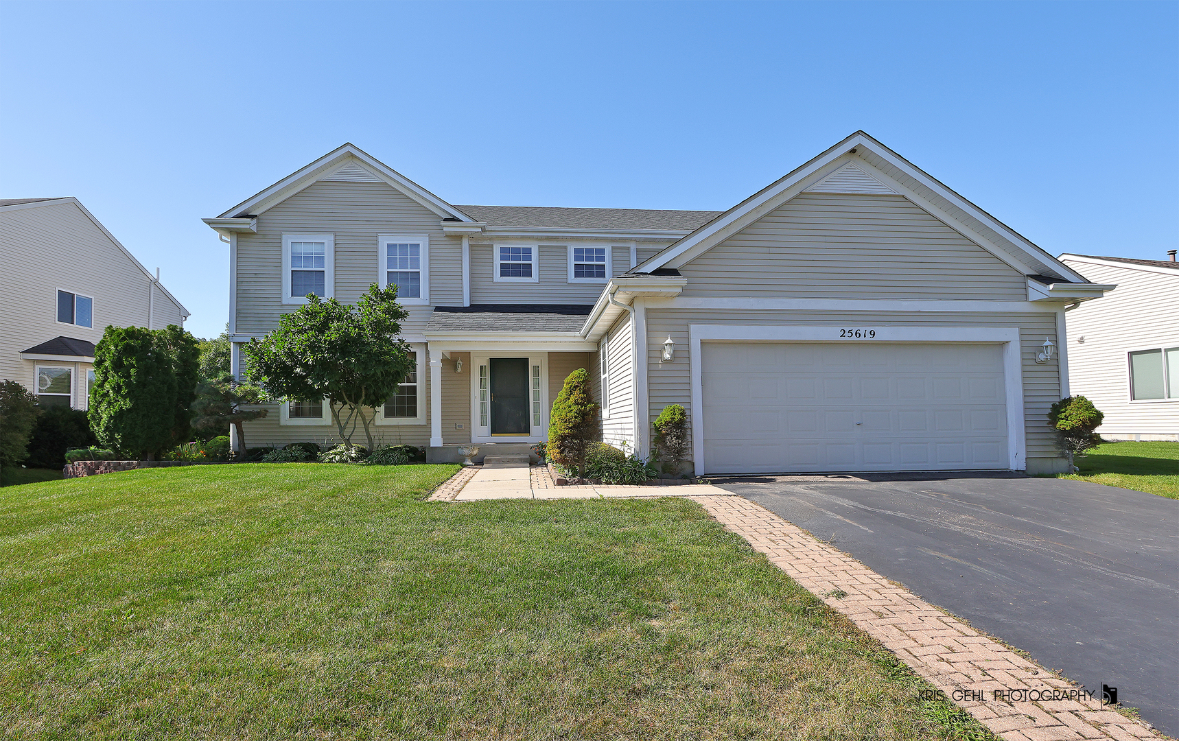a front view of a house with a yard and porch