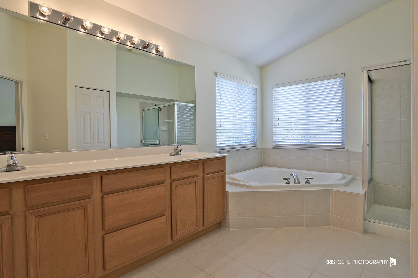 25619 West Bluestem Road Round Lake, IL 60073 - Photo 17 of 33 a bathroom with a tub a double vanity sink and mirror