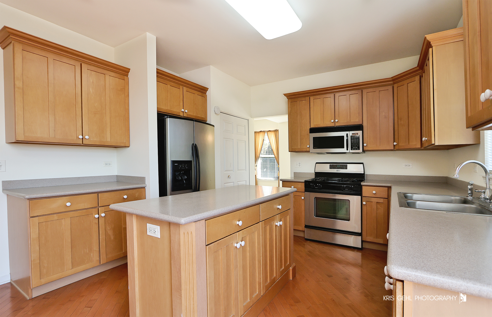 25619 West Bluestem Road Round Lake, IL 60073 - Photo 5 of 33 a kitchen with stainless steel appliances granite countertop a stove a sink and a microwave
