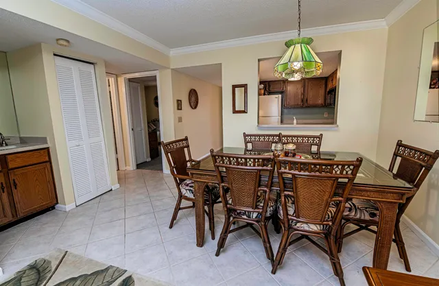 a view of a dining room with furniture and chandelier