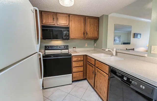 a kitchen with a sink stove and microwave
