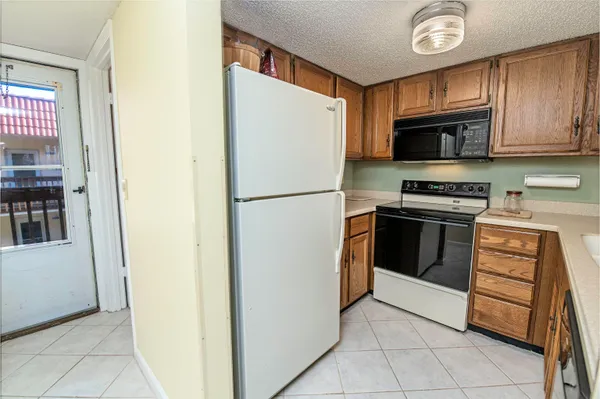 a kitchen with stainless steel appliances granite countertop a refrigerator and a stove