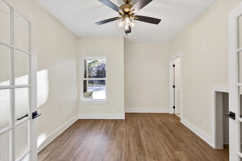 114 Castlewood Road Enchanted Oaks, TX 75156 - Photo 16 of 33 a view of an empty room with wooden floor and a window