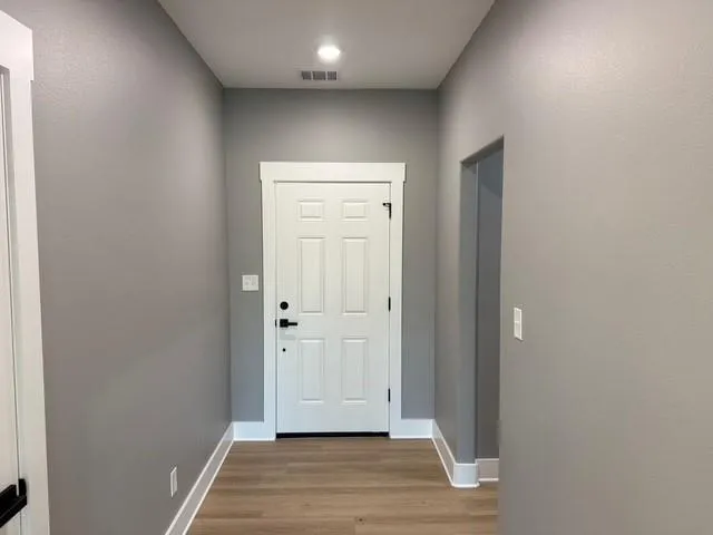 a view of hallway with wooden floor