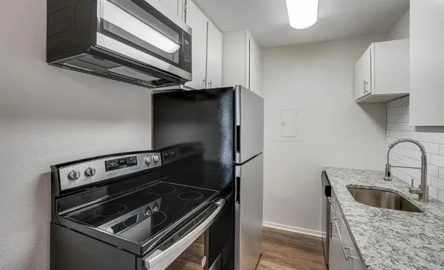 a kitchen with a stove and a microwave