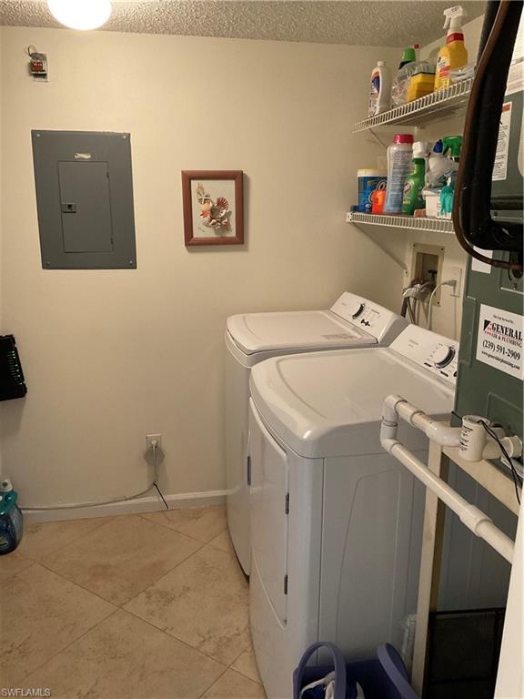6780 Dennis Circle, Unit M103 Naples, FL 34104 - Photo 17 of 23 a utility room with dryer and washer