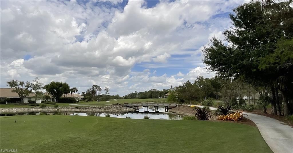 6780 Dennis Circle, Unit M103 Naples, FL 34104 - Photo 21 of 23 a view of a lake with houses