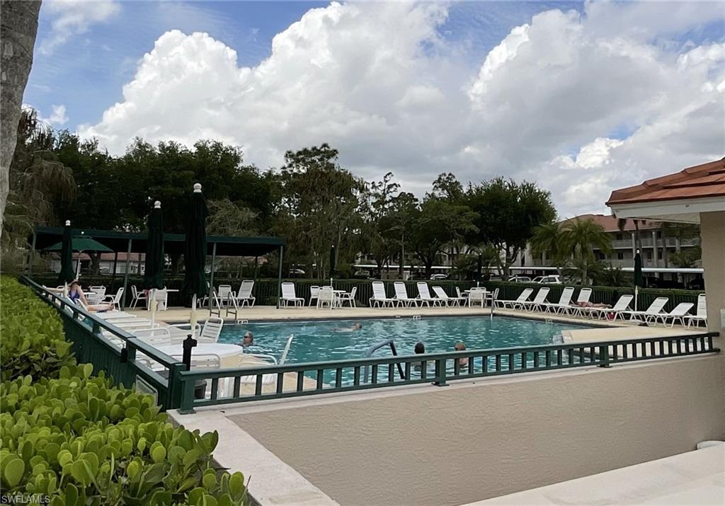 6780 Dennis Circle, Unit M103 Naples, FL 34104 - Photo 22 of 23 a view of swimming pool and outdoor seating