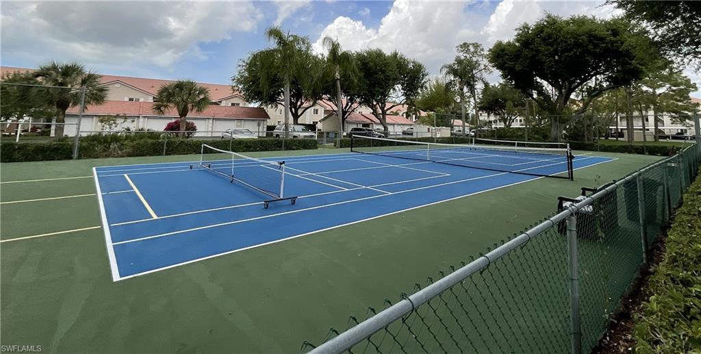 6780 Dennis Circle, Unit M103 Naples, FL 34104 - Photo 23 of 23 a view of an outdoor space and tennis court
