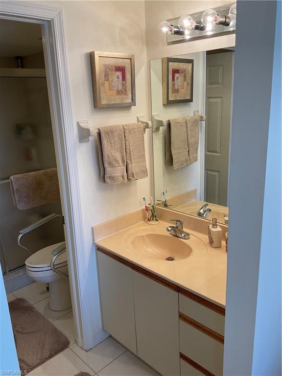 6780 Dennis Circle, Unit M103 Naples, FL 34104 - Photo 7 of 23 a bathroom with a sink and a mirror