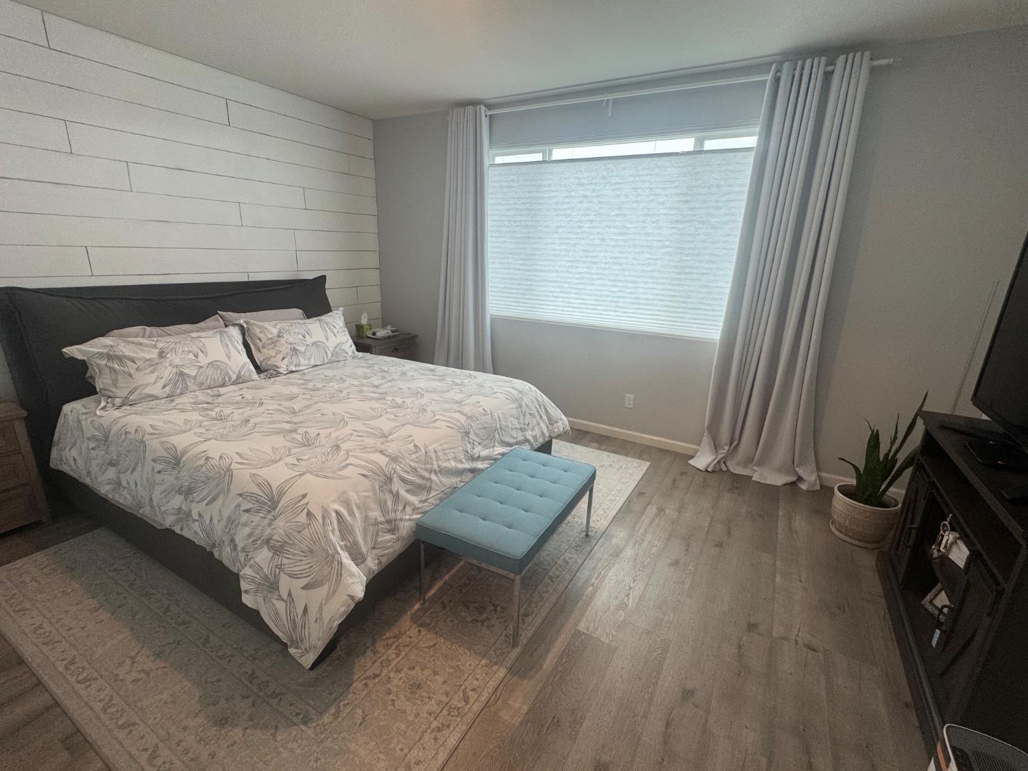 9475 Pasaje Place Elk Grove, CA 95624 - Photo 16 of 26 a bedroom with a bed a mirror and a window