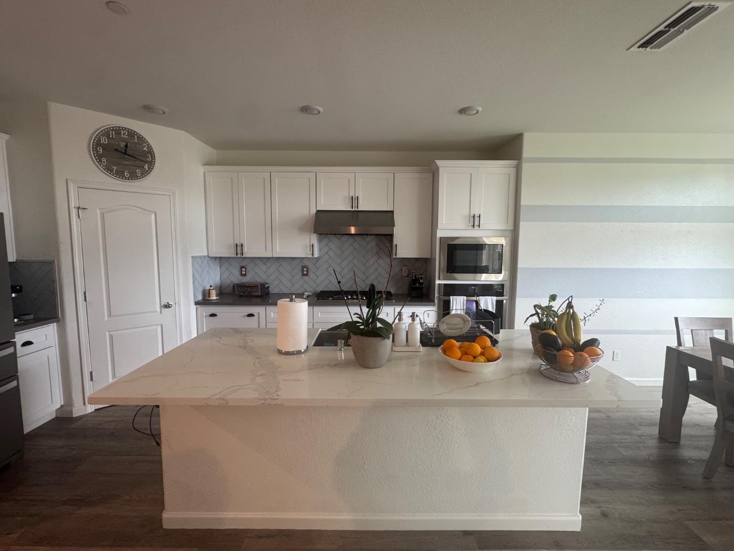 9475 Pasaje Place Elk Grove, CA 95624 - Photo 19 of 26 a kitchen with a refrigerator a stove a sink and a cabinets