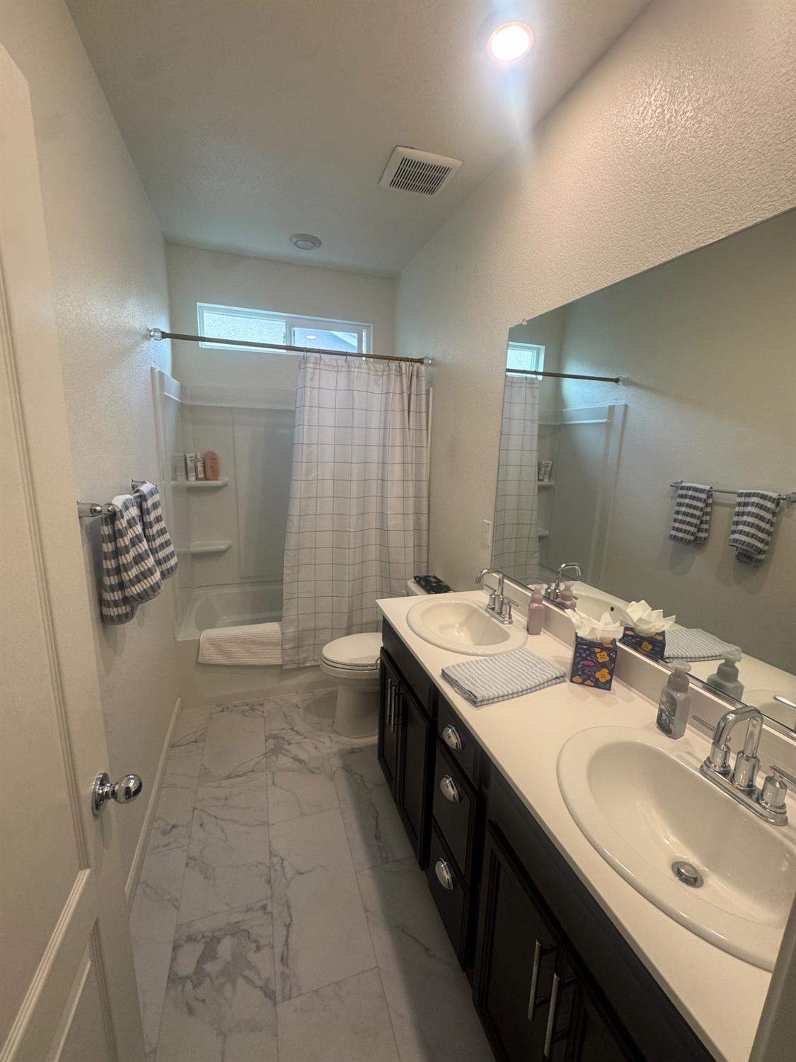 9475 Pasaje Place Elk Grove, CA 95624 - Photo 4 of 26 a bathroom with a double vanity sink toilet and shower