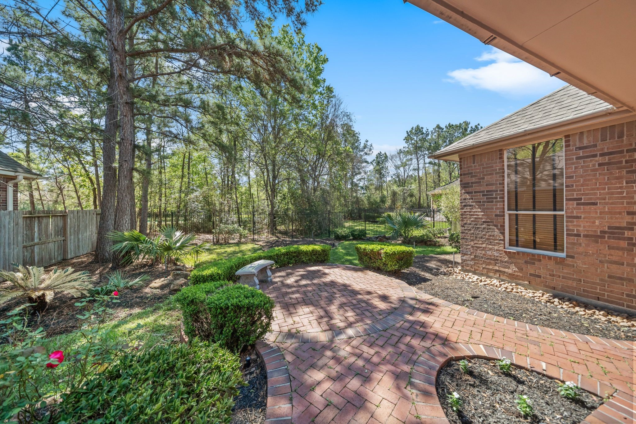 7 Sovereign Way Conroe, TX 77384 - Photo 3 of 31 a view of backyard with potted plants and a large tree