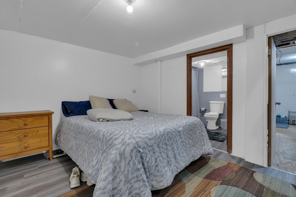 64 Commonwealth Road Watertown, MA 02472 - Photo 16 of 23 a bedroom with a bed and wooden floor
