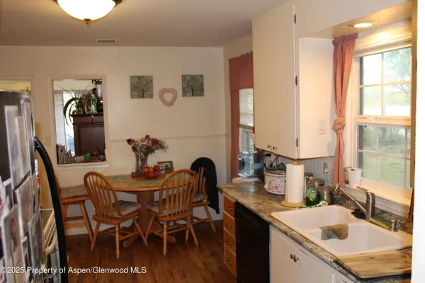 a kitchen with a sink and chairs