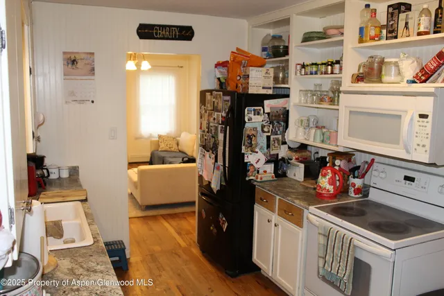 a kitchen with stainless steel appliances granite countertop a stove and cabinets