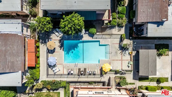 an aerial view of residential houses with outdoor space
