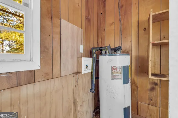 a view of an empty room and window and wooden floor
