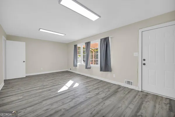 a living room with hard wood floors and a wooden floor