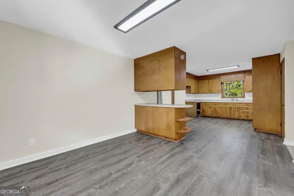 a kitchen with cabinets a sink and appliances