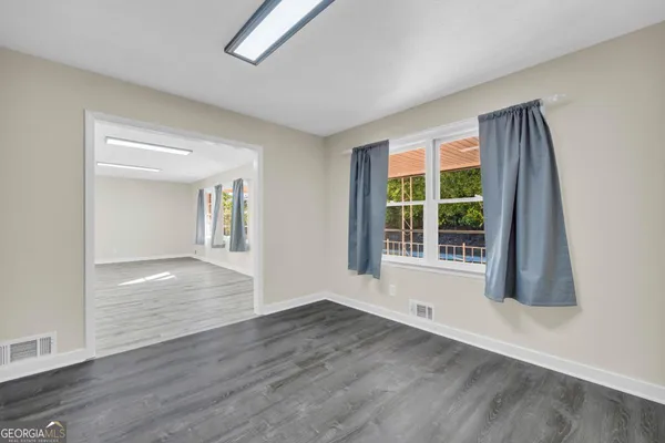 a living room with hard wood floors and a fireplace